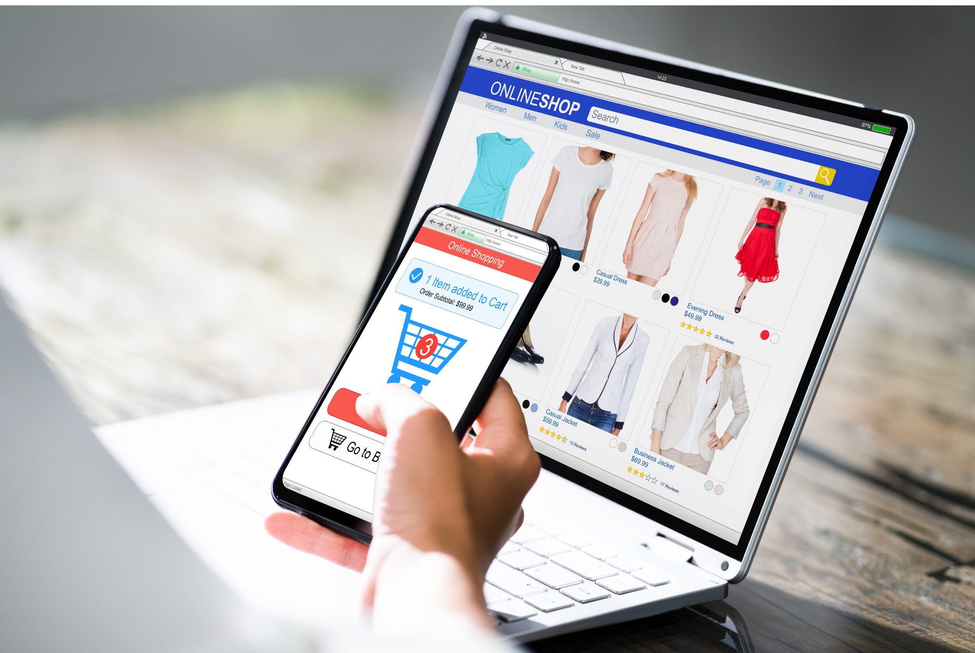 Shopper adding an item to a cart on a smartphone in front of a laptop showing an online clothing store
